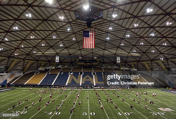 The Arizona Cardinals warm up for training camp at Northern Arizona University Walkup Skydome on August 1, 2010 in Flagstaff, Arizona.