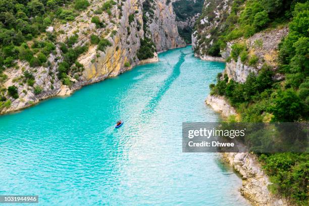 high angle view of two people rafting on turquoise waters, verdon gorge france - rafting stock-fotos und bilder