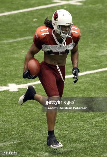 Wide receiver Larry Fitzgerald of the Arizona Cardinals practices in training camp at Northern Arizona University Walkup Skydome on August 1, 2010 in...