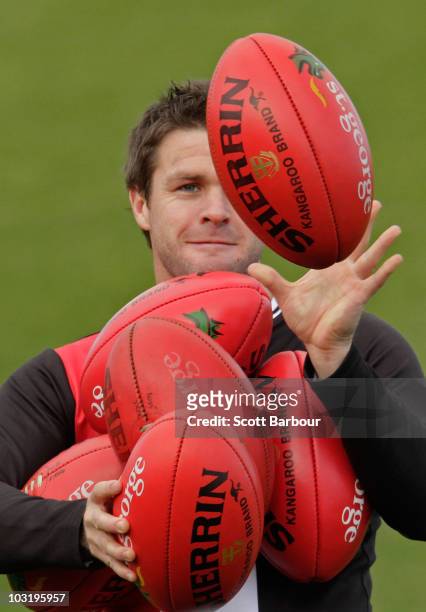 Adam Schneider of the Saints catches footballs during a St Kilda Saints AFL training session at Linen House Oval on August 2, 2010 in Melbourne,...