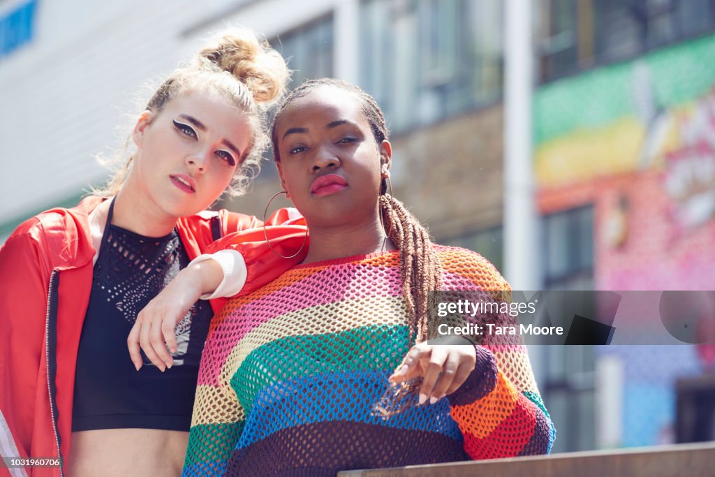 Two fashionable young women in urban environment