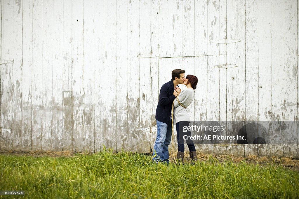 Couple kiss after tug of war