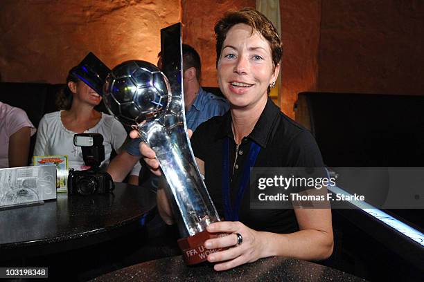 Head coach Maren Meinert poses with the world cup trophy during the Champions Party of the german U20 women's team at the 'Miloudi's Bar' on August...