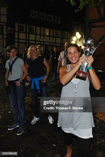 Dzsenifer Marozsan arrives with the world cup trophy during the Champions Party of the German U20 women's team at the 'Miloudi's Bar' on August 1,...