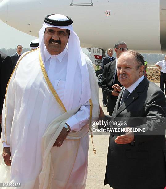 Algerian President Abdelaziz Bouteflika welcomes Qatar's Emir Sheikh Hamad bin Khalifa al-Thani during a welcoming ceremony held at Houari Boumediene...