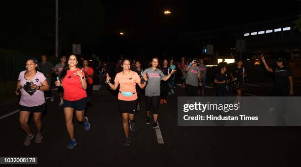 Women participate in the The Fearless Run, a midnight run of 5 kilometers which was organised by the Delhi Police in association with the NGO United...