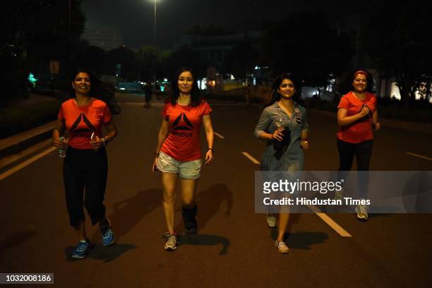 Women participate in the The Fearless Run, a midnight run of 5 kilometers which was organised by the Delhi Police in association with the NGO United...