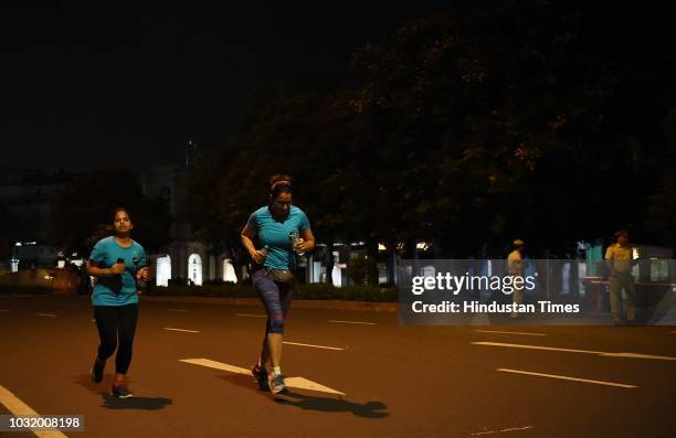 Women participate in the The Fearless Run, a midnight run of 5 kilometers which was organised by the Delhi Police in association with the NGO United...