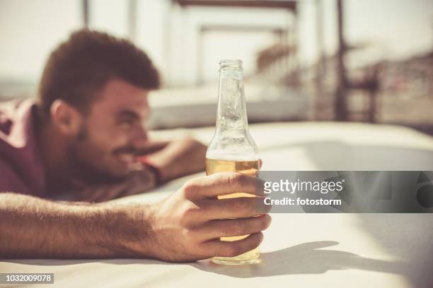 cold beer on a hot day - hand holding a bottle stock pictures, royalty-free photos & images