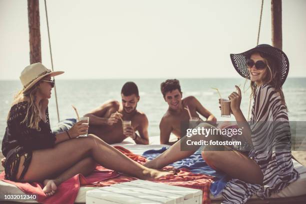 friends relaxing by the sea - bar girl stock pictures, royalty-free photos & images