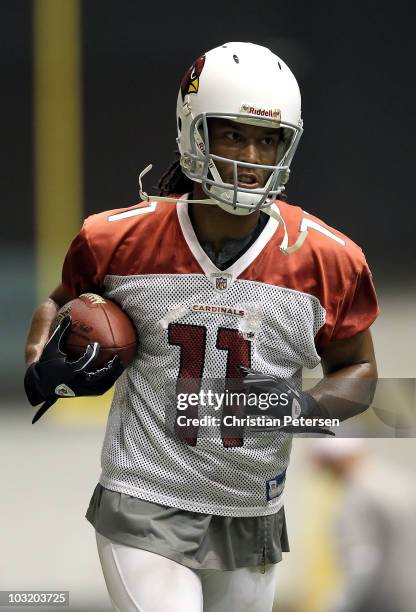 Wide receiver Larry Fitzgerald of the Arizona Cardinals practices in the team training camp at Northern Arizona University Walkup Skydome on August...