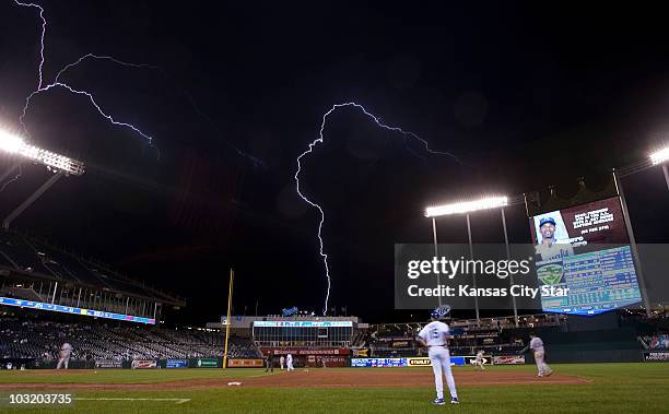 Lightening streaks across the sky in the eighth inning as the Texas Rangers and Kansas City Royals play at Kauffman Stadium in Kansas City, Missouri,...