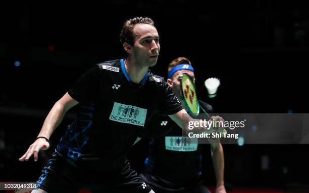 Mathias Boe and Carsten Mogensen of Denmark compete in the Men's Doubles first round match against Mark Lamsfuss and Marvin Emil Seidel of Germany on...