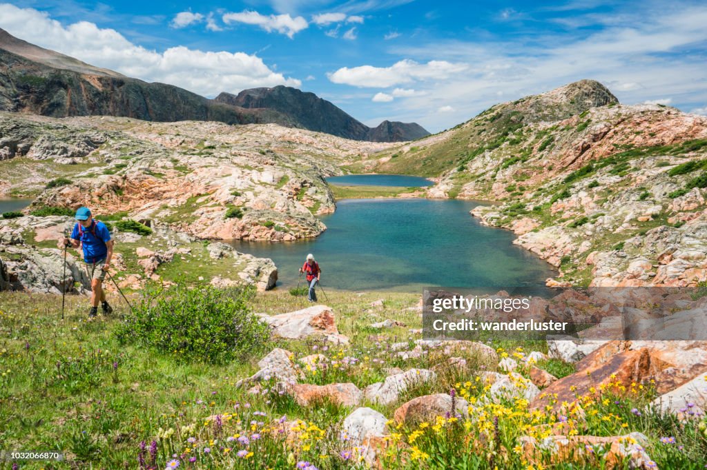 Hikers climb slope from Eldorado lake, San Juan Mountains