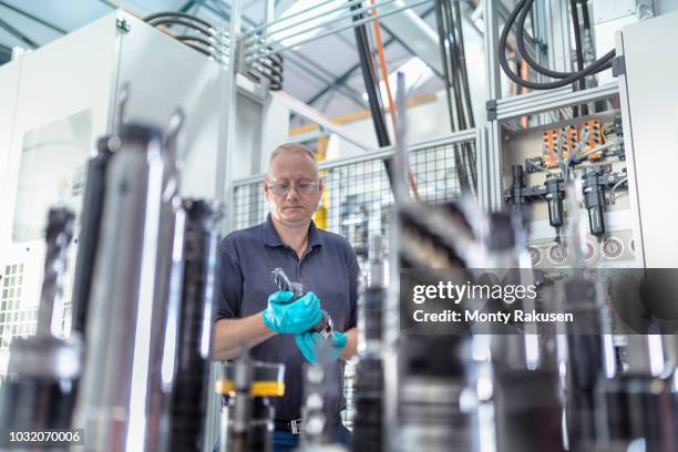 engineer inspecting cnc cutting tools in gearbox factory - cnc stock pictures, royalty-free photos & images