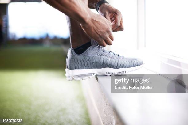 man tying shoelace in gym - black men feet stock pictures, royalty-free photos & images