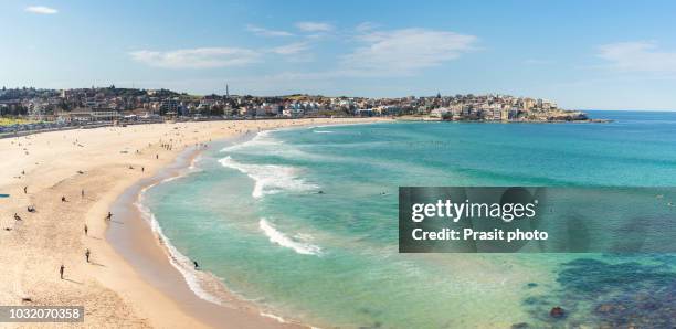 people relaxing on the bondi beach in sydney, australia. bondi beach is one of the most famous beach in the world. - bondi beach sydney stock pictures, royalty-free photos & images