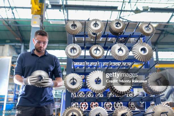 engineer selecting cutting tool in gearbox factory - multi tool stock pictures, royalty-free photos & images