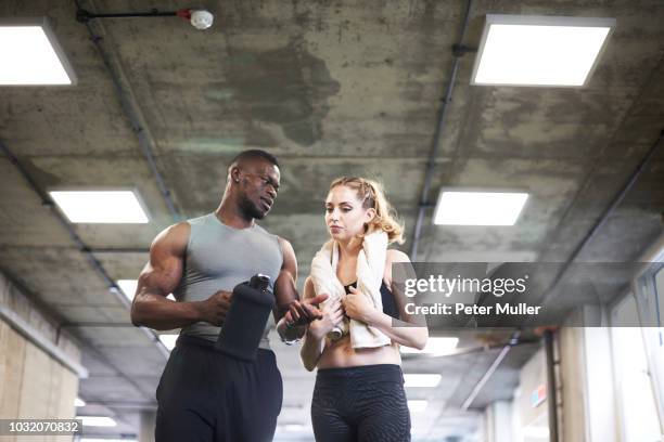 trainer and female client talking in gym - gym coach stock pictures, royalty-free photos & images