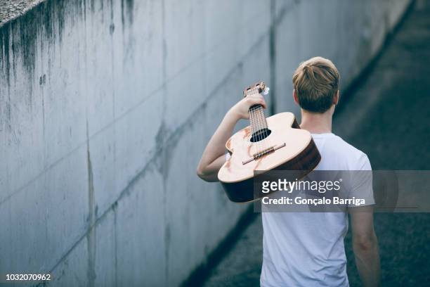 young musician with guitar - chitarra foto e immagini stock