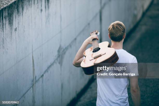 young musician with guitar - busker stock pictures, royalty-free photos & images