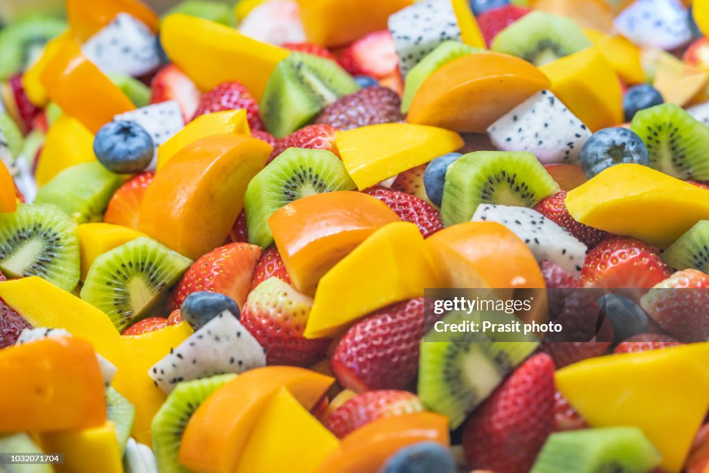 Healthy fresh fruit salad on white background. Top view.Fruit background