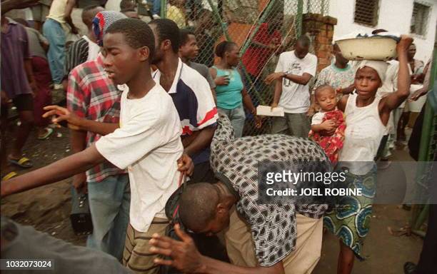 Liberian civilians are frightened by gunshots in the Greystone camp in Monrovia 24 May. Hundreds of Monrovian marched for peace and American...