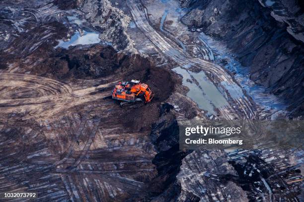 An excavator is seen at the Suncor Energy Inc. Millennium mine in this aerial photograph taken above the Athabasca oil sands near Fort McMurray,...