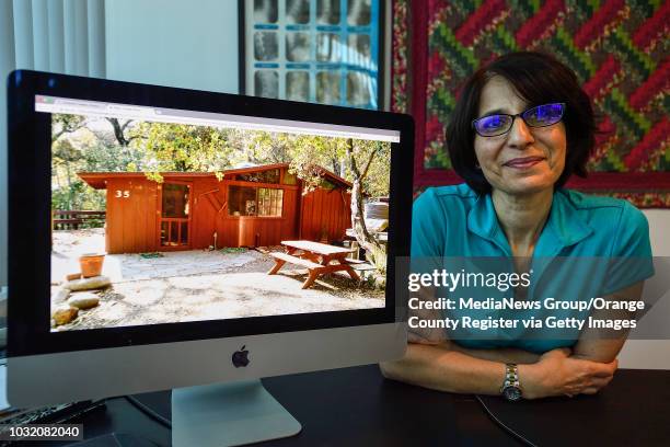 Dr. Mamak Shakib, in her Irvine, CA, office, shows her cabin that burned in the Holy Fire in the Cleveland National Forest on Tuesday, August 7,...