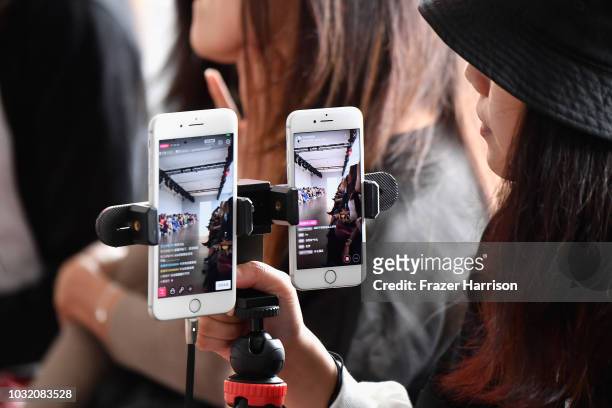 Guest uses her cell phone to film the runway for Semir X CJ Yao fashion show during September 2018 - New York Fashion Week: The Shows at Gallery II...