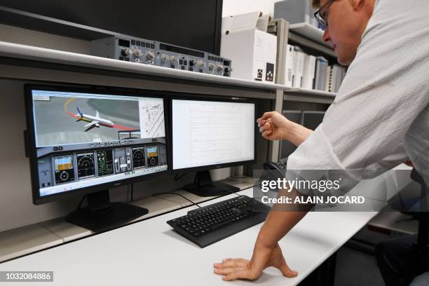 Researcher of the Office of Investigation and Analysis checks the data retrieved from a flight recorder on a computer, in the laboratory of the BEA...