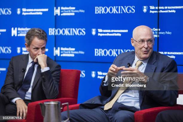 Hank Paulson, chairman and founder of the Paulson Institute and former U.S. Treasury secretary, right, speaks while Tim Geithner, former U.S....