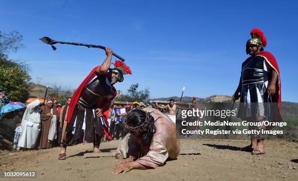 Roman soldiers attack Freddie Gonzalez, portraying Jesus, during a Stations of the Cross hike in Baker Canyon in Silverado on Friday, Mar 30, 2018....