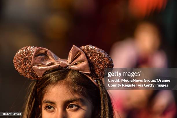 Young girl dons rose gold Mickey Mouse ears at Disney California Adventure Park in Anaheim on Friday, Jan 26, 2018.