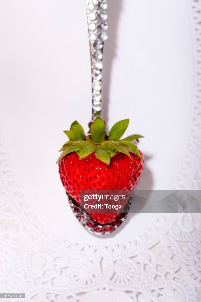 Spoon covered in diamonds with perfect strawberry