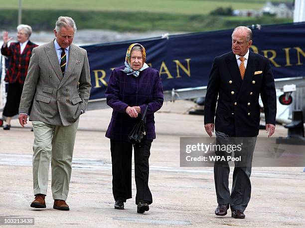 The Queen Elizabeth II with Prince Philip, The Duke of Edinburgh accompanied by the Prince Charles, Prince of Wales as they leave the Hebridean...