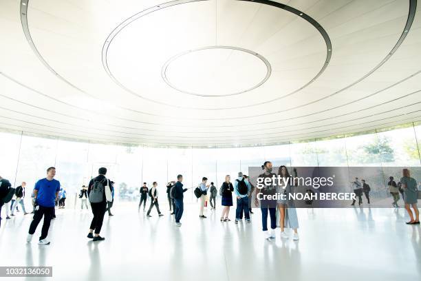 Attendees wait for a product announcement event to begin at the Apple Cupertino, California, headquarters on September 12, 2018. - New iPhones set to...