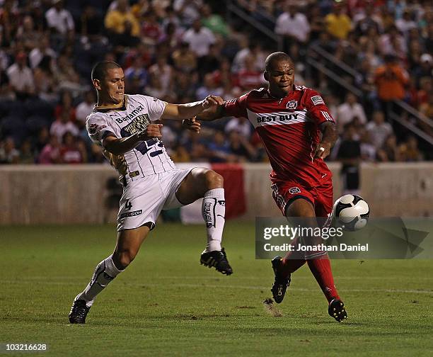 Collins John of the Chicago Fire holds off Dario Veron of Pumas UNAM during a SuperLiga 2010 match at Toyota Park on July 20, 2010 in Bridgeview,...