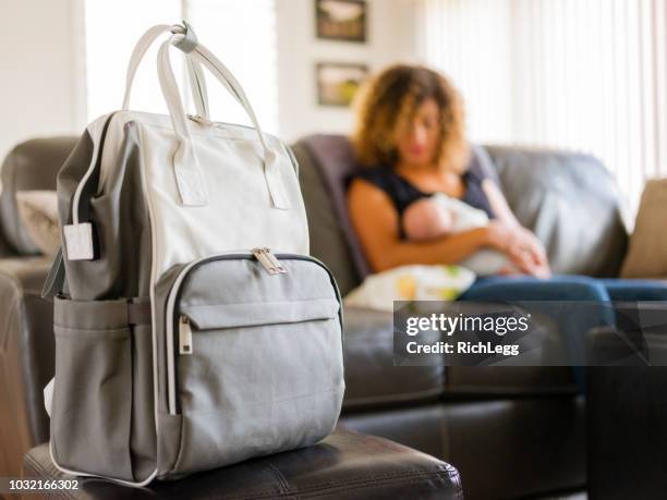 mom and newborn baby in a home - diaper bag stock pictures, royalty-free photos & images