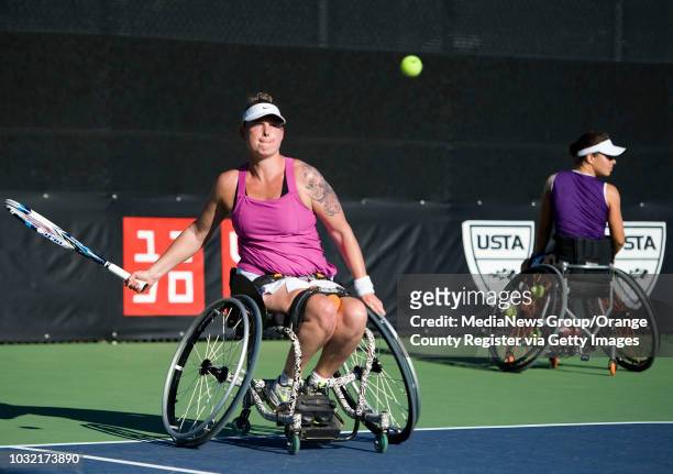 Michaela Spaanstra, of the Netherlands, hits the ball as her partner Marjolein Buis, looks on during their doubles semi-final match in the UNIQLO...