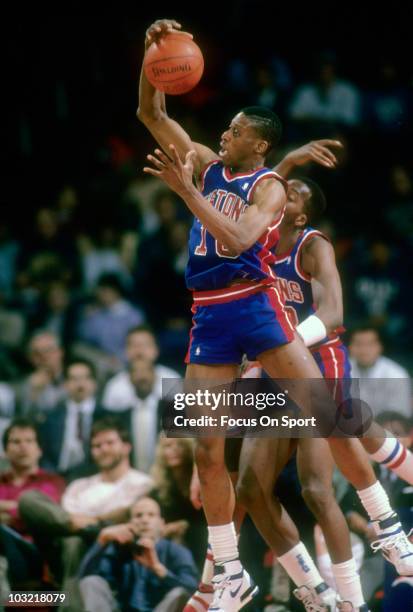 Dennis Rodman of the Detroit Pistons pulls down a rebound against the Washington Bullets circa 1988 during an NBA basketball game at the Capital...