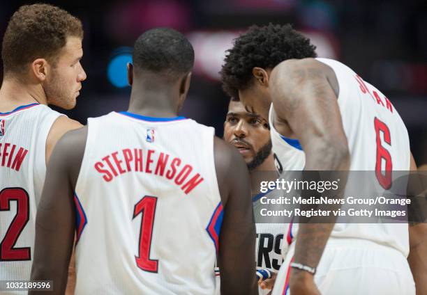 The Clippers' Chris Paul talks with teammates Blake Griffin, Lance Stephenson and DeAndre Jordan during the Clippers' 115-109 victory over the...