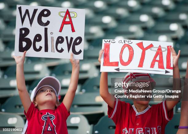 Angel fans Olivia and Jake Ledoyen, formerly of Aliso Viejo, cheer on the Halos before their 5-3 loss to the Rangers Thursday night at Globe Life...