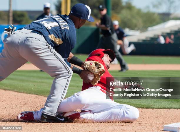 The Angels' Matt Joyce is tagged out at third by the Brewers' Luis Jimenez during the Halos' Spring Training home opener at Tempe Diablo Stadium...