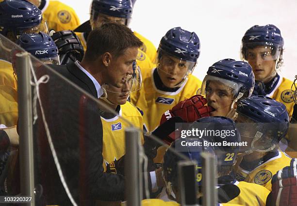 Head coach Roger Ronnberg of Team Sweden speaks with his players during a game against Team USA at the USA Hockey National Evaluation Camp on August...