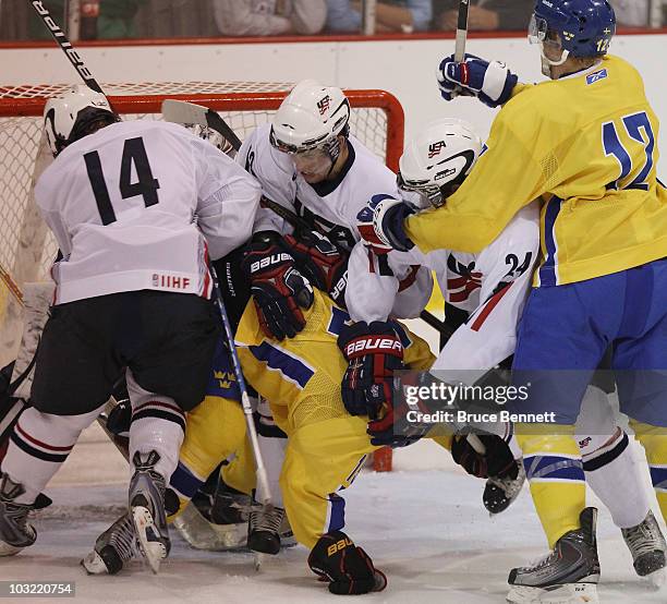 Calle Jarnkrok of Team Sweden is pushed around in the crease in his game against Team USA at the USA Hockey National Evaluation Camp on August 3,...