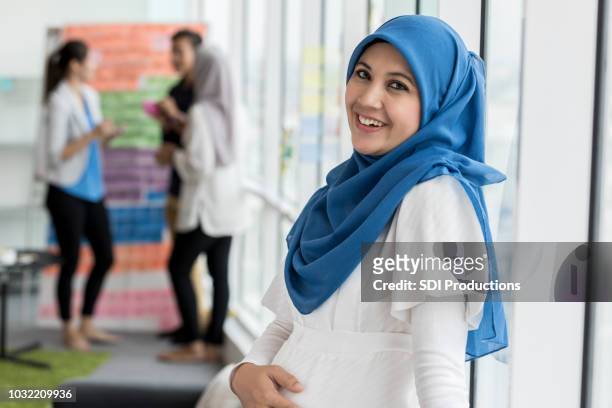 confident pregnant businesswoman - pregnant muslim stock pictures, royalty-free photos & images