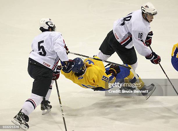 Calle Jarnkrok of Team Sweden is hit by Kyle Palmieri and John Norman of Team USA at the USA Hockey National Evaluation Camp game on August 3, 2010...