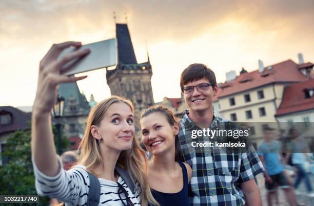 friends on vacation taking selfie - prague tourist stock pictures, royalty-free photos & images