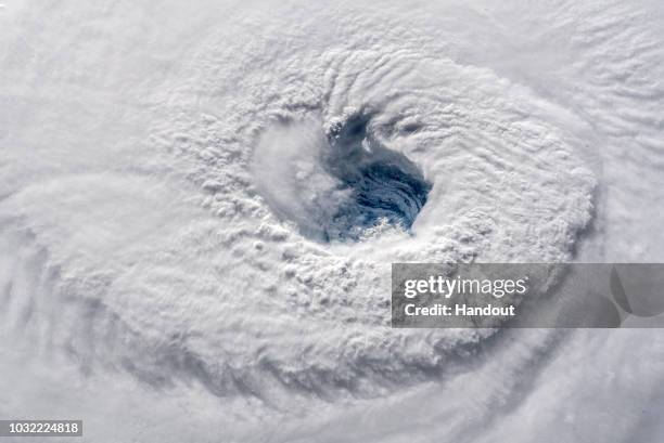 In this satellite image provided by the National Aeronatics and Space Administration and European Space Agency , Hurricane Florence churns through...